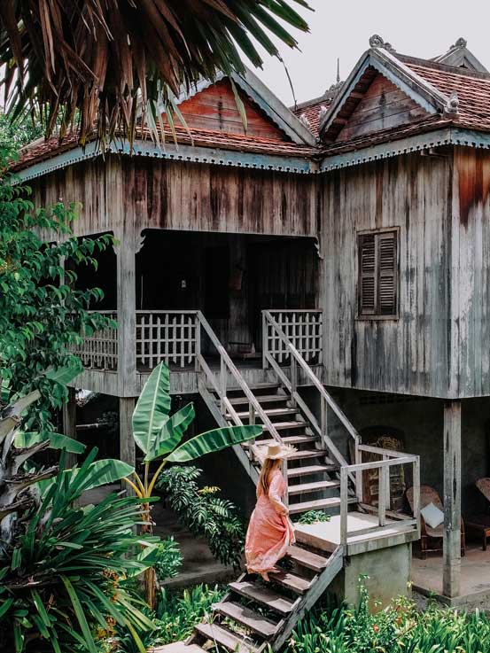 Experience Luxury and Authenticity at Siem Reap_s Best Hotel Salalodges Woman walking up steps to room at Sala Lodges