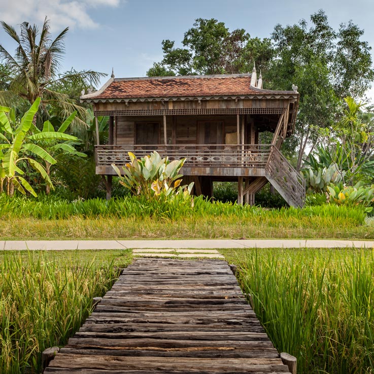 Woman walking up steps to room at Sala Lodges